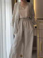 Two-piece Set Featuring A Casual Knit Cotton Top With Cut-out Details And Contrasting Color Trims, Paired With Linen-cotton Blend Trousers.