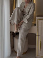 Two-piece Set Featuring A Casual Knit Cotton Top With Cut-out Details And Contrasting Color Trims, Paired With Linen-cotton Blend Trousers.