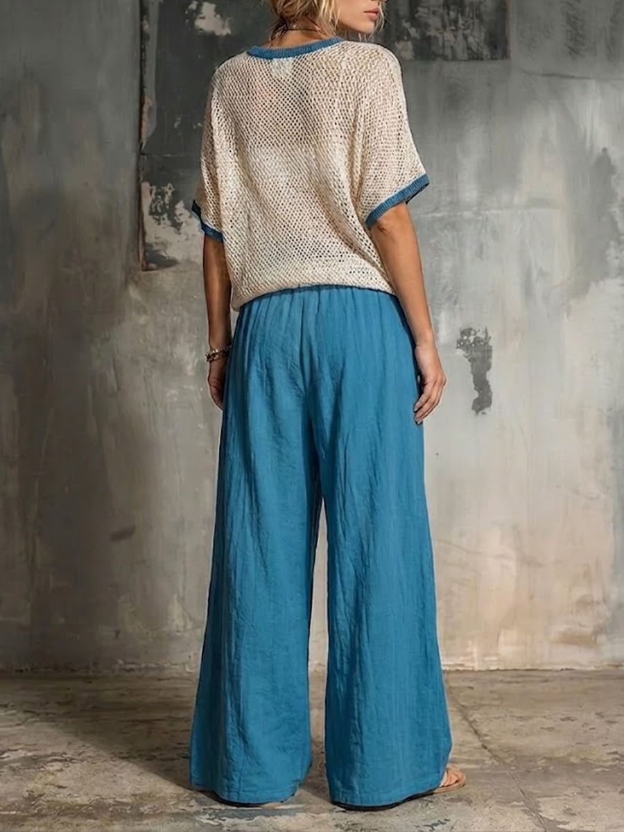 Two-piece Set Featuring A Casual Knit Cotton Top With Cut-out Details And Contrasting Color Trims, Paired With Linen-cotton Blend Trousers.