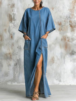 Washed Denim Ankle-length Dress Featuring A Round Neck, Dropped Shoulders, Wide Elbow-length Sleeves, Side Slits, And Large Patch Pockets In A Loose Fit