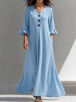 Long Dress Featuring A Partial Button-front, Gathered Details, Ruffled Three-quarter Sleeves, And A Flattering, Figure-concealing Fit