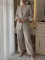 Two-piece Set Featuring A Casual Knit Cotton Top With Cut-out Details And Contrasting Color Trims, Paired With Linen-cotton Blend Trousers.